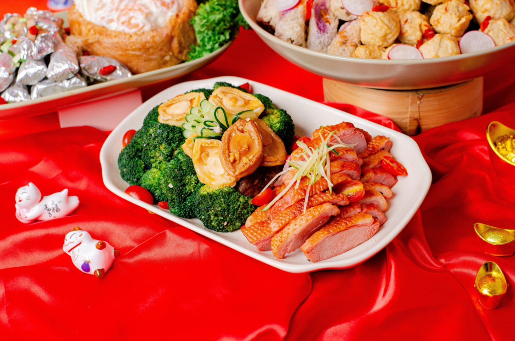chinese new year smoked duck slices served on white plate 2