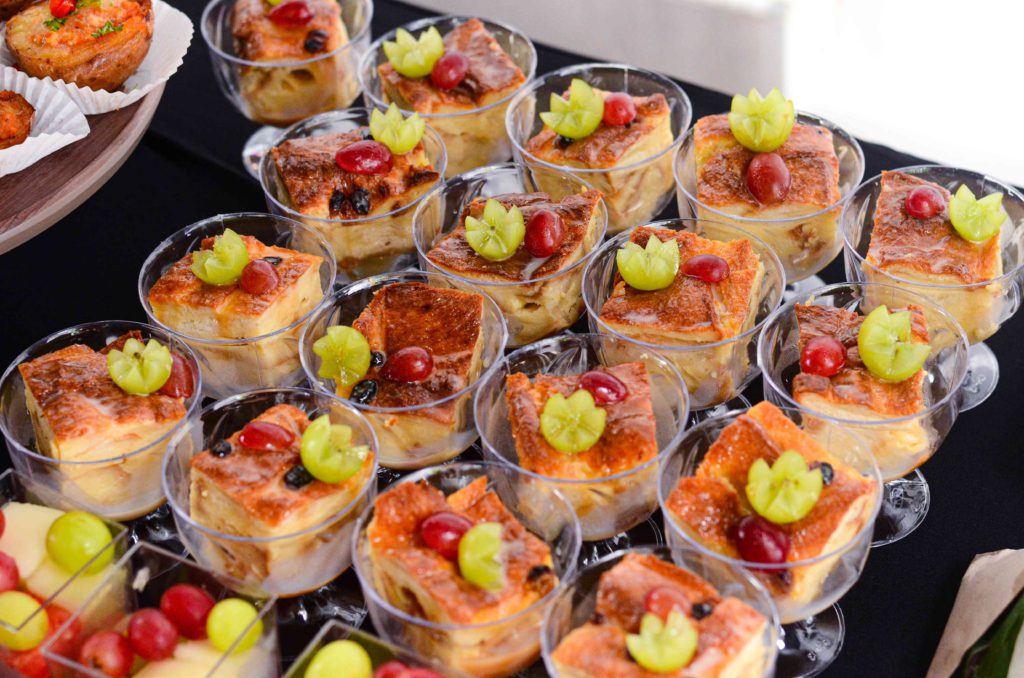 Square cakes in transparent cups for a catering event by idocatering